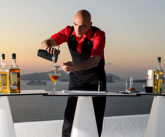 Grand Ambassador Santorini Hotel barman making drinks